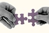 Jigsaw pieces hands mergers acquisitions